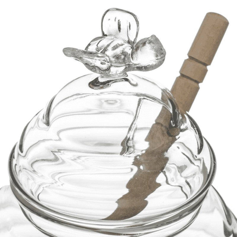 Glass honey pot with wooden dipper